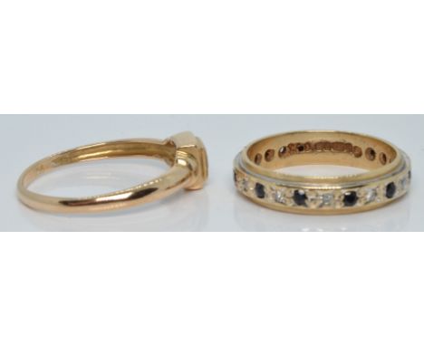 A 9ct gold eternity ring set with diamonds and sapphires (size K) and a 9ct gold ring set with a square cut topaz (size M/N),