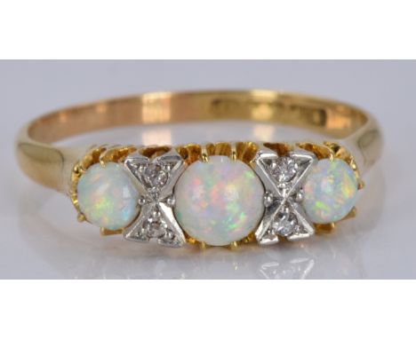 An 18ct gold ring set with opals and diamonds, 3.5g, size R