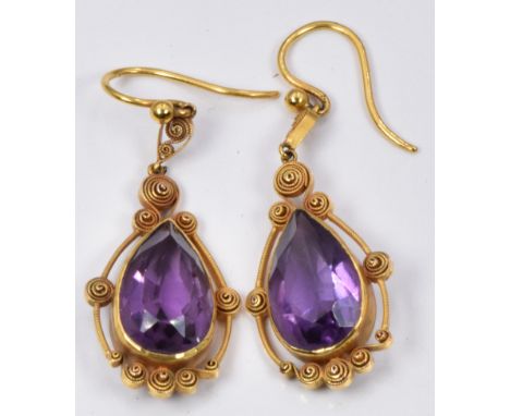 A pair of Victorian earrings set with a pear cut amethyst and filigree decoration to each, in original David Hall Ltd jewelle