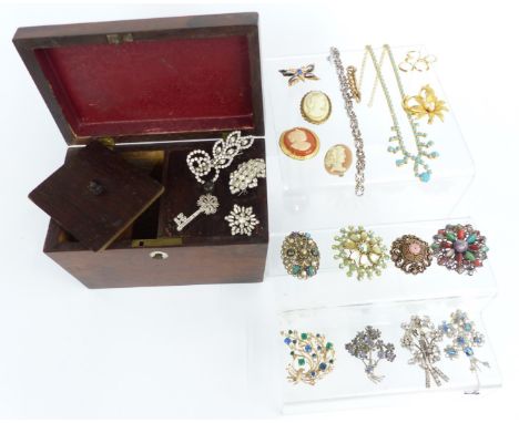 A collection of costume jewellery, including brooches, diamanté etc, in a wooden tea caddy