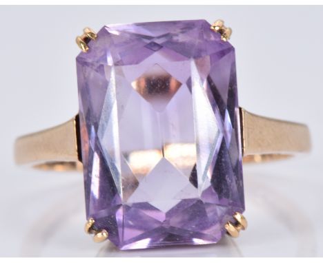 A 9ct gold ring set with a mixed emerald cut amethyst, 3.6g, size L