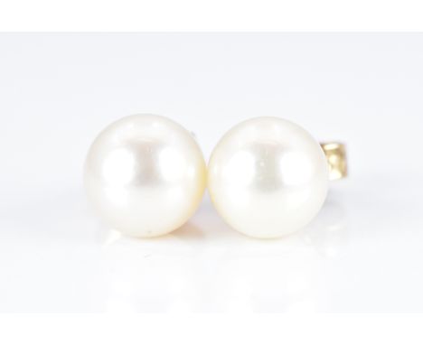 A pair of 9ct gold earrings set with a pearl to each