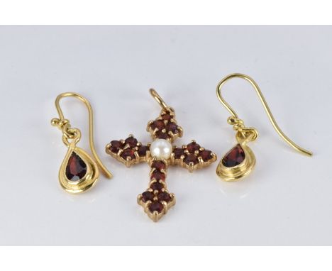 A 9ct gold cross pendant set with a pearl and garnets and a pair of yellow metal earrings set with a garnet to each&nbsp;