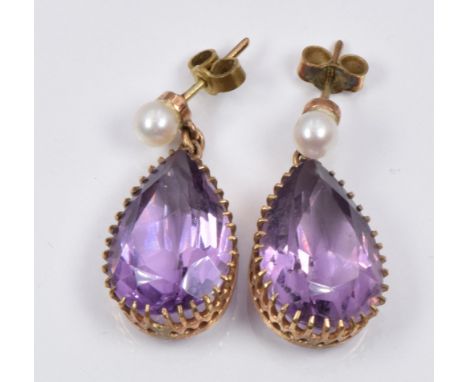 A pair of earrings each set with a pear cut amethyst and a pearl to the stud, 0.5 x 2cm