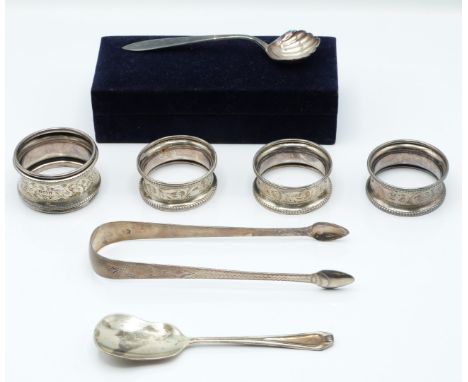 Four hallmarked silver napkin rings, Georgian hallmarked silver bright cut sugar tongs, hallmarked silver caddy spoon and a s