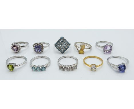 Ten silver rings set with zircon, fluorite, blue topaz, ametrine, tanzanite, amethyst, peridot, and opal, with certificates