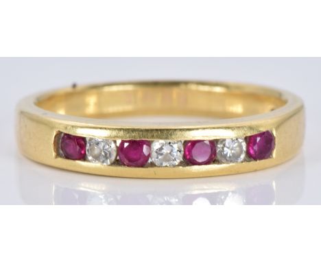 An 18ct gold ring set with alternating rubies and diamonds, 3.8g, size N&nbsp;