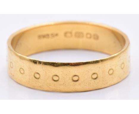 A 22ct gold wedding band/ ring with circular decoration,4.6g, size S