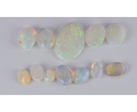 Eleven loose oval opal cabochons