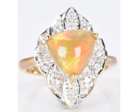 A 9ct gold ring set with a Kalimaya trilliant cut opal surrounded by white sapphires, 5.1g, size M