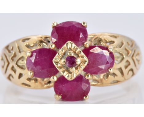 A 9ct gold ring set with rubies with engraved shoulders, 3.5g, size N