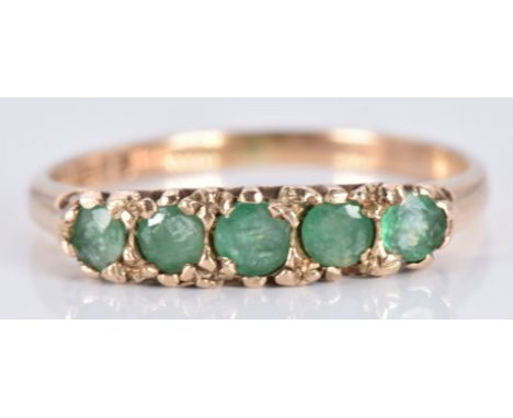 A 9ct gold ring set with emeralds, 1.8g, size M