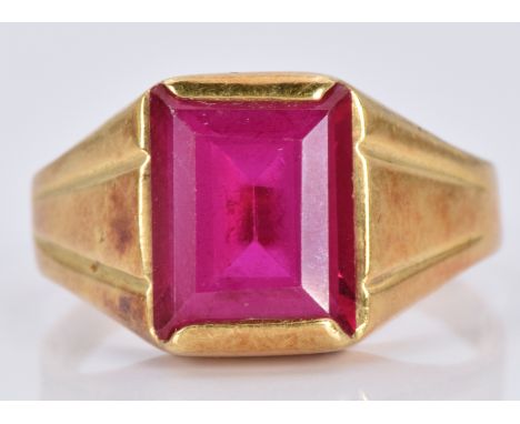 An 18ct gold ring set with an emerald cut synthetic ruby, 5.5g, size P