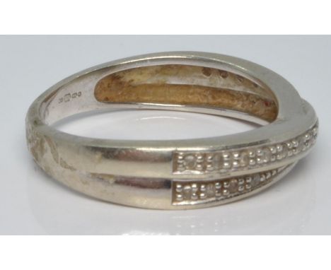A 9ct white gold ring set with diamonds in a cross over setting, 2.8g, size M&nbsp;