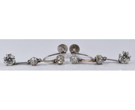 A pair of Art Deco 9ct white gold earrings set with three old cut diamonds, the largest approximately 0.52ct. L-3cm, 3g