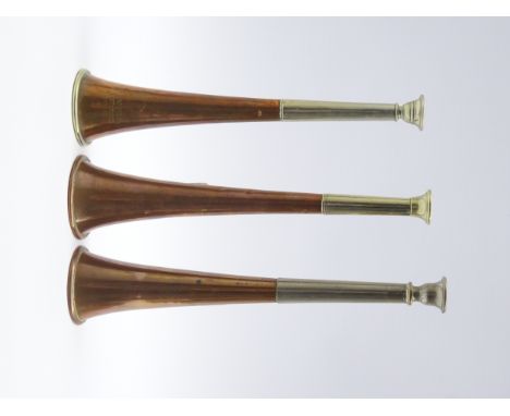 Three copper and nickel hunting horns by Kohler & sons and Army & Navy C.S.L and another unmarked, H25cm Condition Report & F