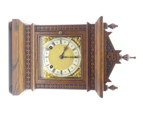 Late 19th century oak bracket clock, arched top with triple final pediment, geometric carved decoration, twin train movement 
