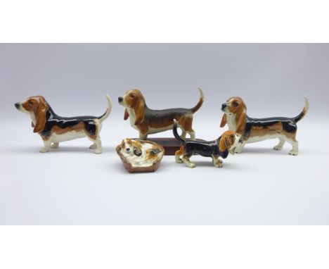 Three Beswick Basset Hound models, Royal Doulton Cocker Spaniel in basket and a Goebel Basset Hound (5) Condition Report & Fu