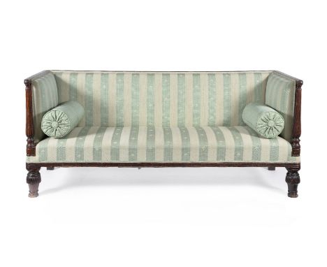 A Regency mahogany sofa, circa 1815, the rectangular back and arms with a reeded cresting rail and upholstered in striped gre