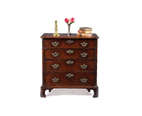 A George II walnut chest of drawers, circa 1730, the serpentine fronted top with moulded edge above four long graduated drawe