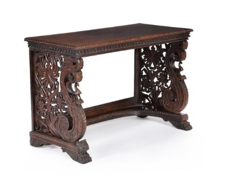 A pair of Anglo Indian carved hardwood console tables, circa 1825, each rectangular top with a guilloche carved edge and repe