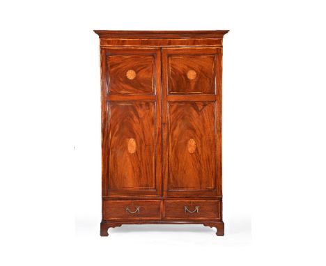 A George III mahogany wardrobe, probably Channel Islands, circa 1800, the moulded cornice above a pair of panelled doors open