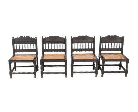 ϒA set of four Ceylonese ebony chairs, first half 19th century, each carved profusely with floral and foliate decoration thro