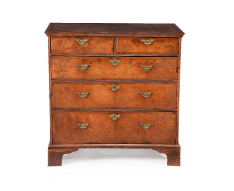 A George II walnut chest of drawers, circa 1735,  the rectangular quarter veneered top with moulded edge, above two short and