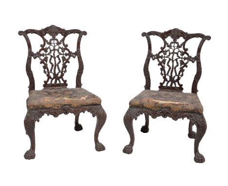 A pair of carved mahogany chairs, in George III style, 19th century, after a design by Thomas Chippendale, carved throughout 