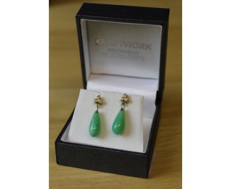 A pair of 18ct gold diamond and jade earrings, with three small diamonds measuring 0.06cts over a tear-drop jade pendant, mar