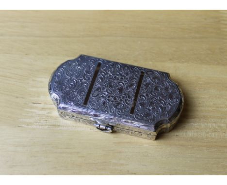 A Continental white metal double compact, the shaped body with leaf and geometric engraved body, 8.5cm x 4.5cm, stamped .900,