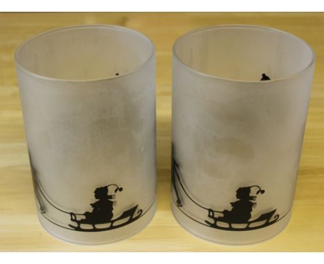A pair of glass 'hurricane lamp' t-light holders, with festive silhouette design 15cm high. Good condition.