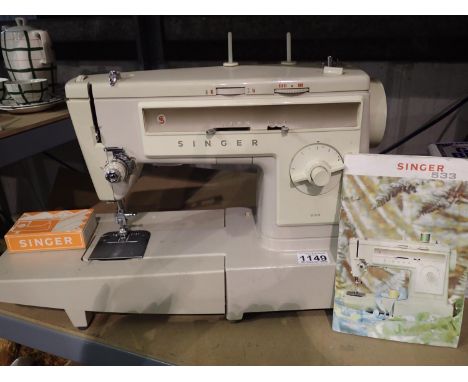 Singer 533 electric sewing machine with instruction booklet. All electrical items in this lot have been PAT tested for safety