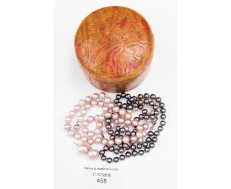 Two cultured pearl single row necklaces: one of pink colour with a 14 ct white gold clasp, approx 6.5-7.0 mm; the other of bl