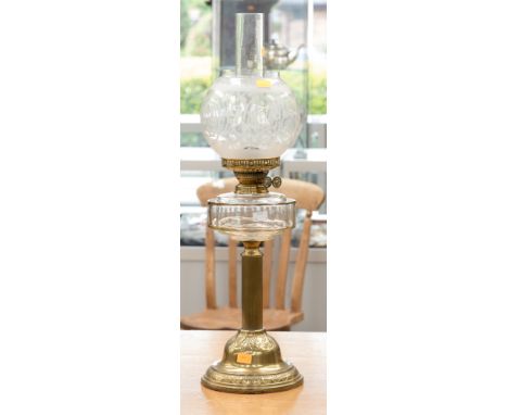 A late Victorian brass based oil lamp, clear glass reservoir and acid etched globe shade