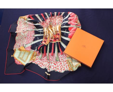 A boxed Hermes silk scarf with ribbon, purchased ten years ago in Madrid, Spain, design depicts a hunting scene with red and 