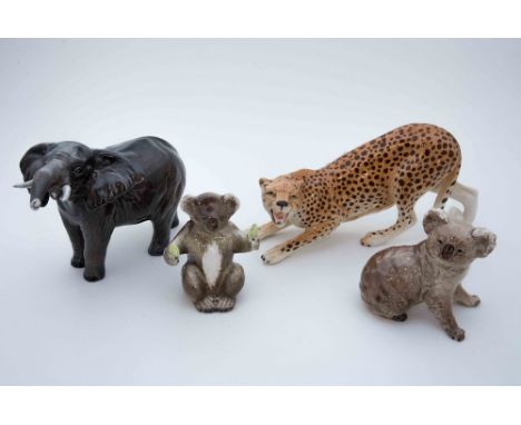 Four Beswick wild animal figures, comprising 'Cheetah' standing, model No 3009, 'Koala with Fruit', model No 1089, Koala mode