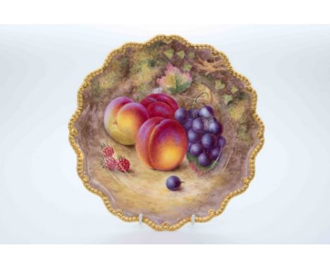 A Royal Worcester hand painted fruit plate, depicting peaches and grapes, signed 'H Ayton', finished with a gilded edge