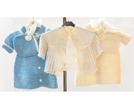 A 1920/30s knitted coat and bonnet and a blue knitted baby's coat and bonnet with white trim on sleeves, a 1920s crotcheted b