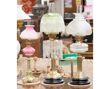 A Duplex oil lamp, clear glass reservoir, etched glass shade, together with another Duplex brass oil lamp, clear glass reserv