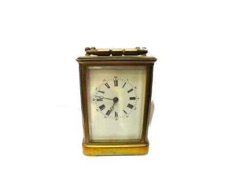 A French brass carriage clock, circa 1890, corniche case, white enamel dial with Roman numerals, visible escapement, the move