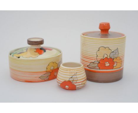 Clarice Cliff for Wilkinson, an Orange Capri, floral banded drum preserve pot, together with a shallow pot and a Newport must