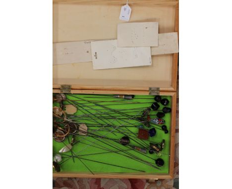 A collection of hat pins to include goldstone, paste, enamel, mother-of-pearl, and tiger's eye finials, also a pair of decora