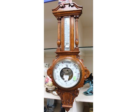 An early 20th Century aneroid oak case barometer and thermometer