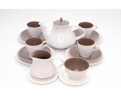 A Poole pottery tea service with teapot, milk and sugar, in two tone brown/beige, 1960s, plus two Poole cockle plates (approx
