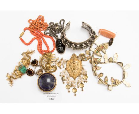 A white metal Slave bangle with heavy rope twist detail, together with two Chinese gilt metal wirework, also Dragon brooches 