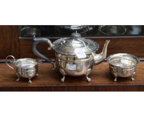 An Edwardian silver three piece tea service, comprising teapot, milk jug and sugar bowl, maker J. Sherwood & Sons, hallmark B