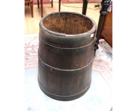 A late 19th Century oak and iron bound barrel, bearing a painted coat of arms