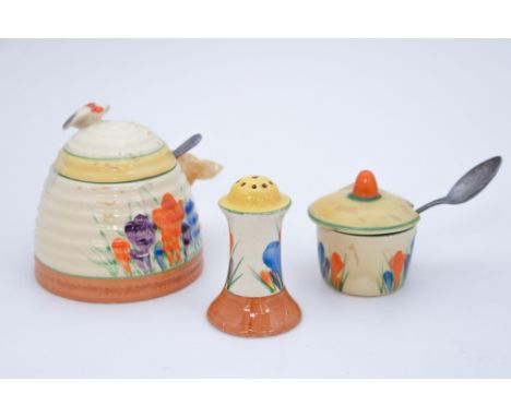 A Clarice Cliff 'Crocus' honey pot and cover with a Bee finial, with a Clarice Cliff 'Crocus' pepper pot and cover (3)
