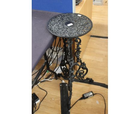 A cast tripod plant stand